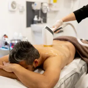 Man receiving laser hair removal on back