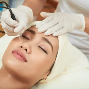 Woman receiving microdermabrasion facial treatment