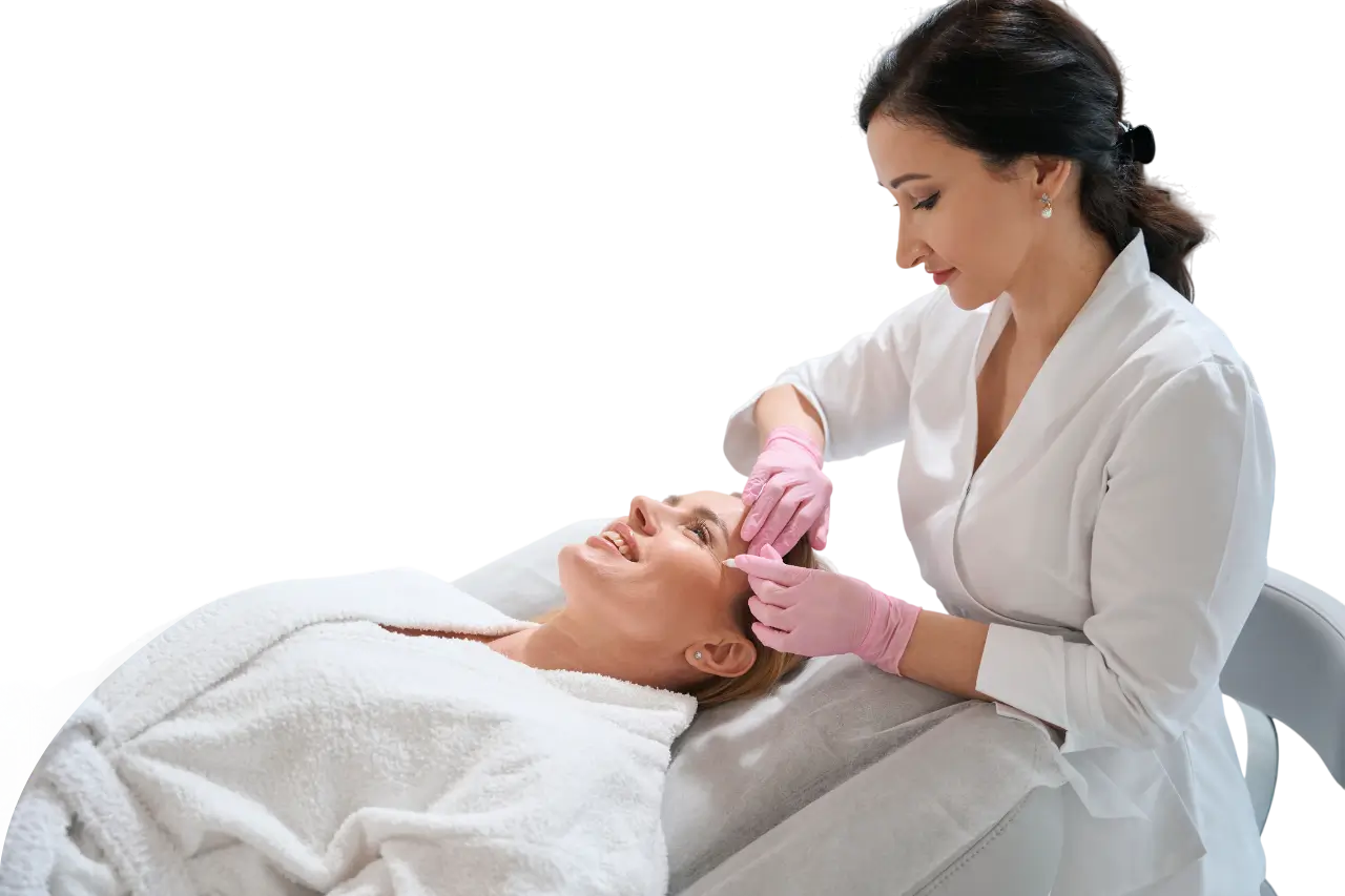 Clinician giving facial injection to reclining woman